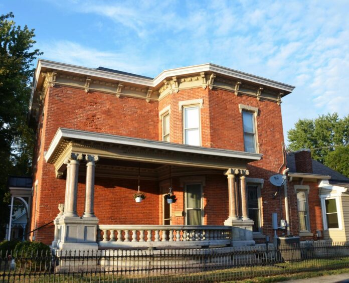Historic brick house with a covered porch.
